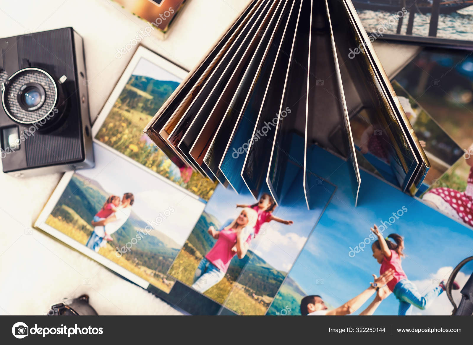 Photo album with photos of travel and vintage old camera Stock Photo by  ©sinenkiy 322250144